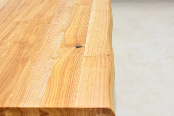Wooden dinner table surface. Natural wood furniture close view isolated over solid background. Solid wood table top