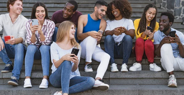 Young Multiracial Group Friends Using Mobile Smartphone Sitting Stairs Out — Stock Photo, Image