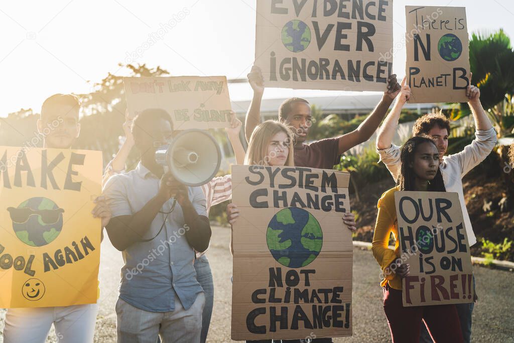 Group of activists protesting for climate change - Multiracial people fighting on road holding banners over environments disasters - Global warming concept
