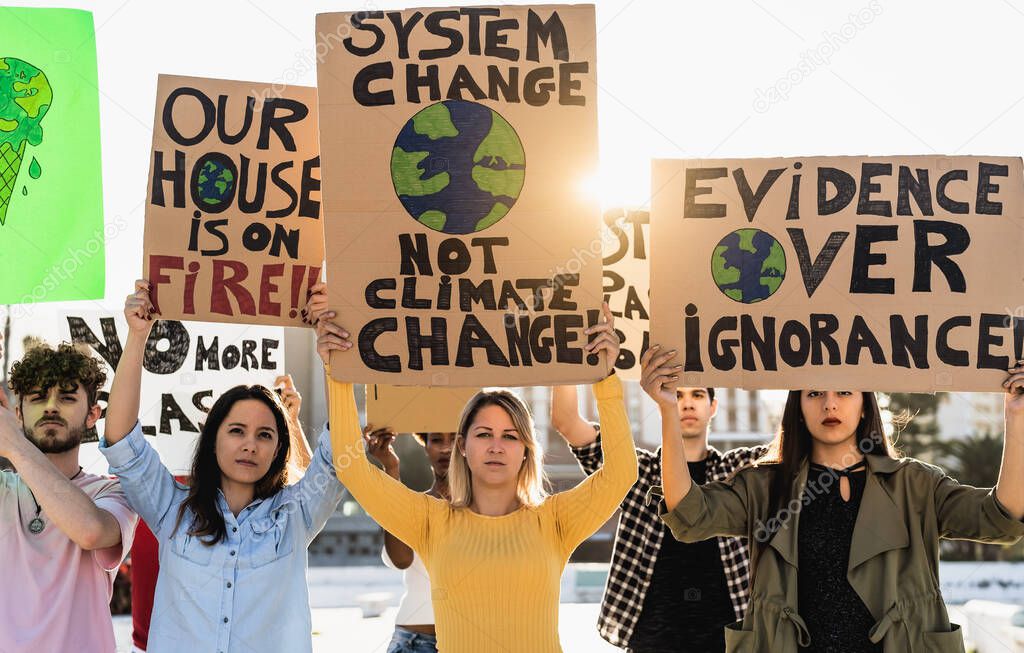 Group of young and diverse activists protesting for climate change - Global warming concept