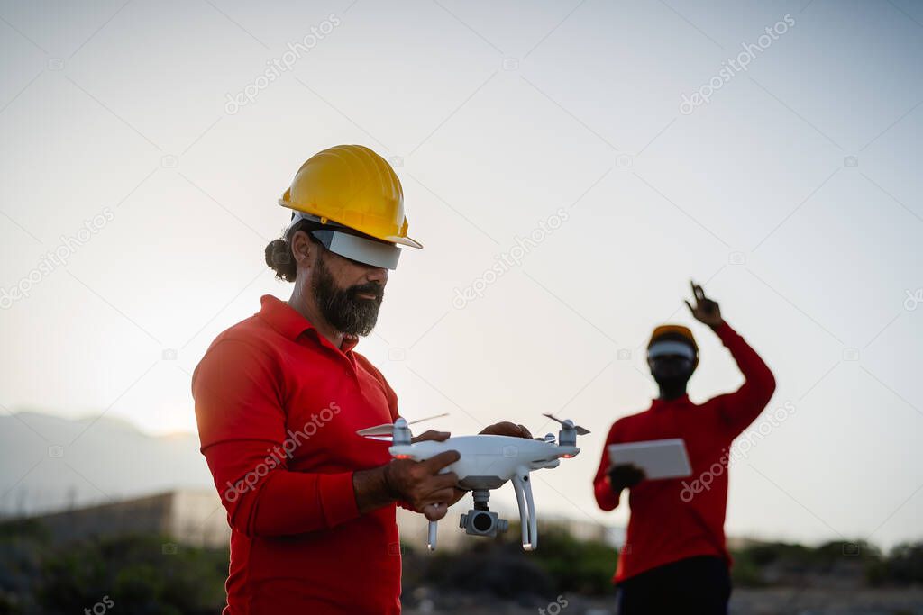 Drone engineer working with futuristic glasses on construction site - Aerial engineering concept
