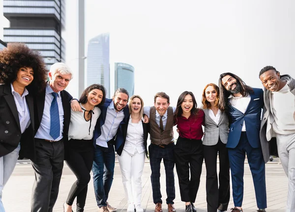 Team of multiracial business people with different ages and ethnicities standing in the city center during meeting work