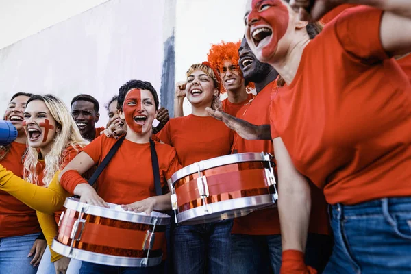 Football fans having fun cheering their favorite team - Soccer sport entertainment concept