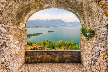 Scenic rock arch balcony overlooking the scenic Lake Garda, Italy