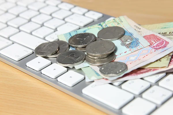 Online transaction concept, dirhams on top of keyboard — Stock Photo, Image