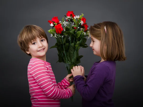 Children romantic with red roses — Stock Photo, Image