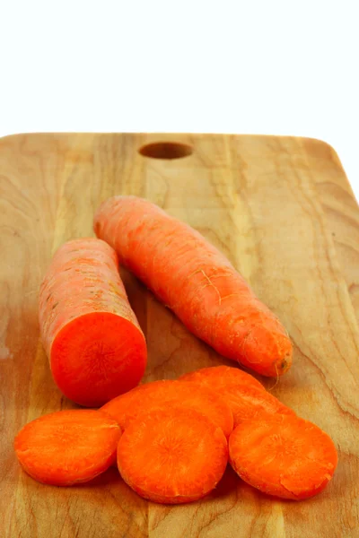 Carrots on wooden board — Stok fotoğraf