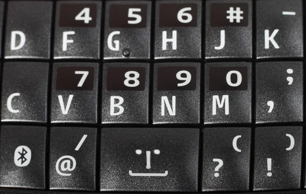 Smartphone keypad with smile macro closeup — Stock Photo, Image
