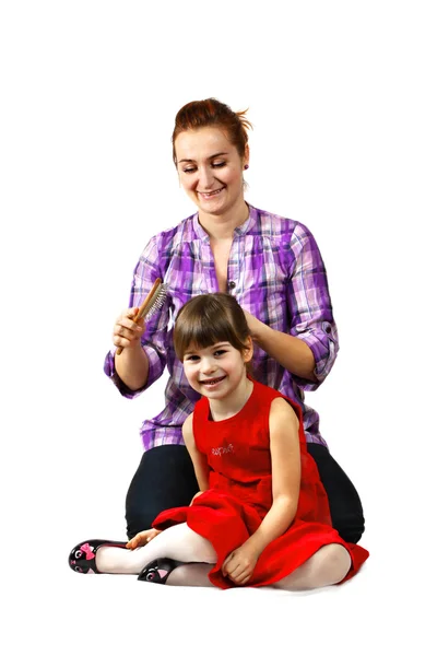 Mother combing daughter's hair — Stock Photo, Image