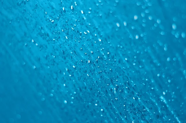 Капли воды на текстурированное стекло — стоковое фото