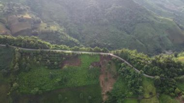 Sabah yağmur yağdıktan sonra dağların tepesindeki gökyüzü manzarası sisli ve yeşil orman, Doi sakad, Pua, Nan, Tayland. Güzel dağları aşarak yol üzerinden ulaşım. İHA 'dan ateşlenmiş..
