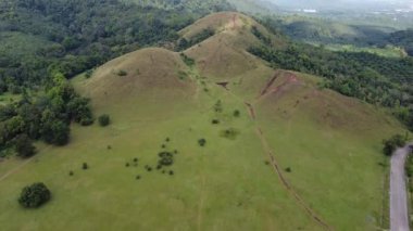 4K Kel Dağ ya da Phu Khao Ya üzerinde yeşil çimen ve mavi gökyüzü. Tayland 'ın Ranong eyaletindeki doğal seyahat cazibelerinden biri.