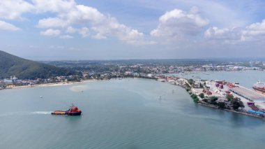 Songkhla island, Thailand - February 2022 : Aerial view of transportation industrial shipping business and cargo ship container. Located on a peninsula that separates the estuary.