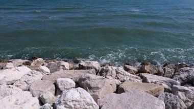 Waves break on the rocks of the cliff