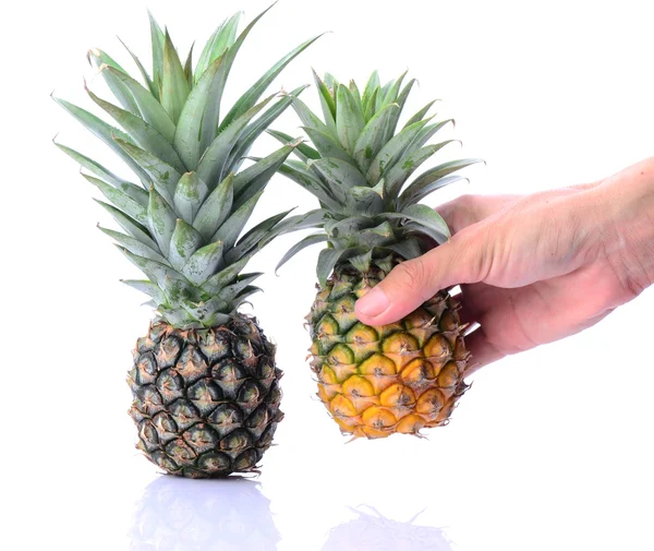 Man's hand picking up pineapple — Stock Photo, Image