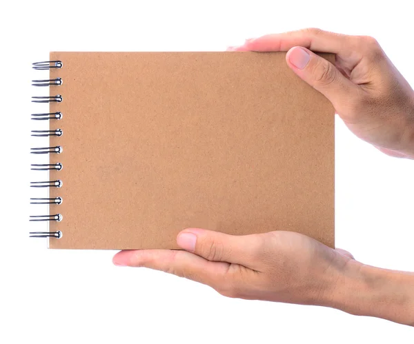 Hands presenting brown notebook — Stock Photo, Image