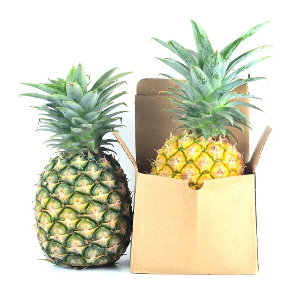 Pineapple and brown box. — Stock Photo, Image
