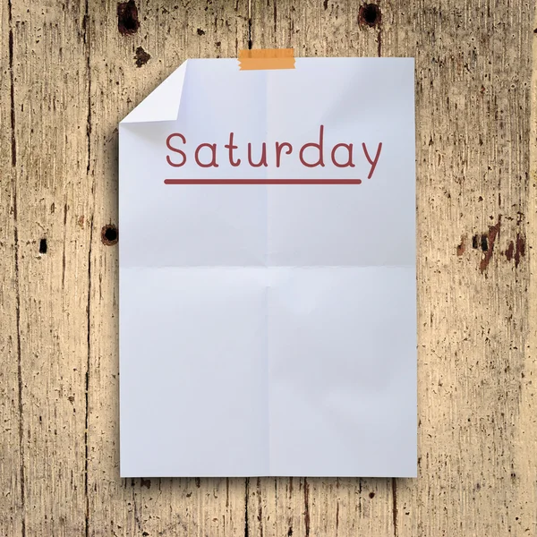 Saturday planning on white fold paper with grunge retro wall pan — Stock Photo, Image