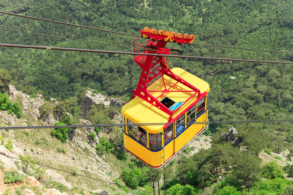 MISHOR, CRIMEA, UKRAINE - MAY 12. People travel by rope way cab on top of Ai-Petri Mountain on May 12, 2013 in Mishor, Ukraine.Russia. This road has one of the longest unsupported span in Europe.