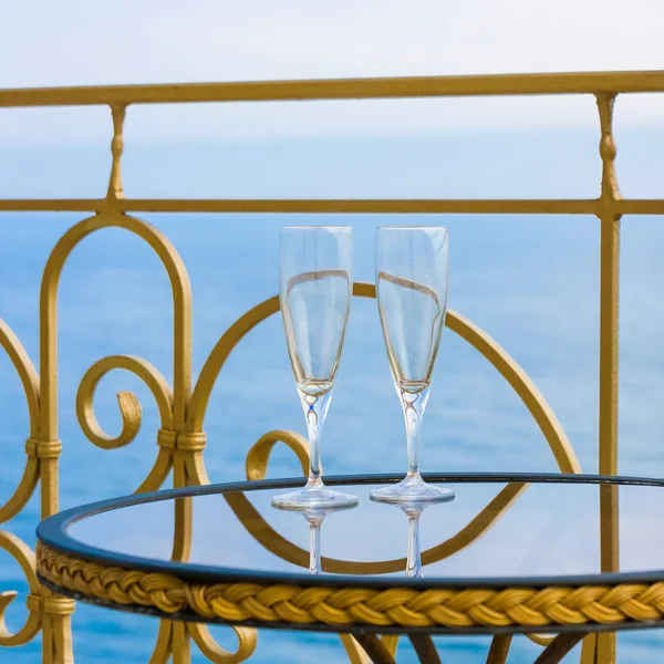 Dwie szklanki kryształowe na stole z widokiem na morze — Zdjęcie stockowe