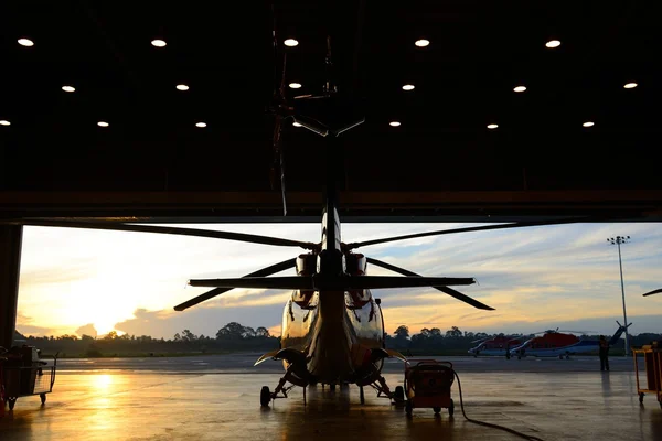 Silhouette of helicopter in the hangar — Stock Photo, Image