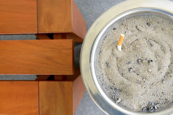 Cigarette in sand ashtray bin — Stock Photo, Image