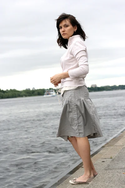 Woman on the river bank — Stock Photo, Image