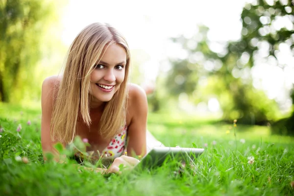 Young woman using tablet outdoor Royalty Free Stock Images