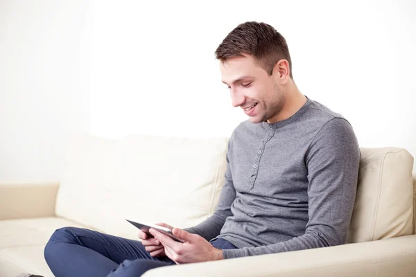 Homem bonito feliz usando tablet digital — Fotografia de Stock