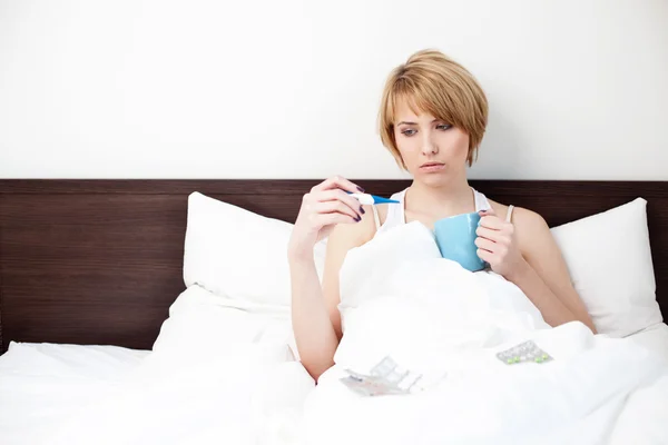 Sick woman measuring body temperature — Stock Photo, Image