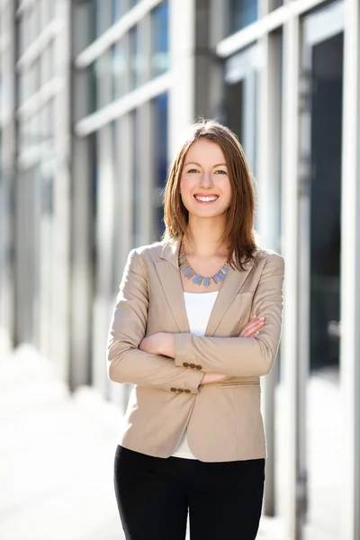 Businesswoman standing at front of office building Stock Photo