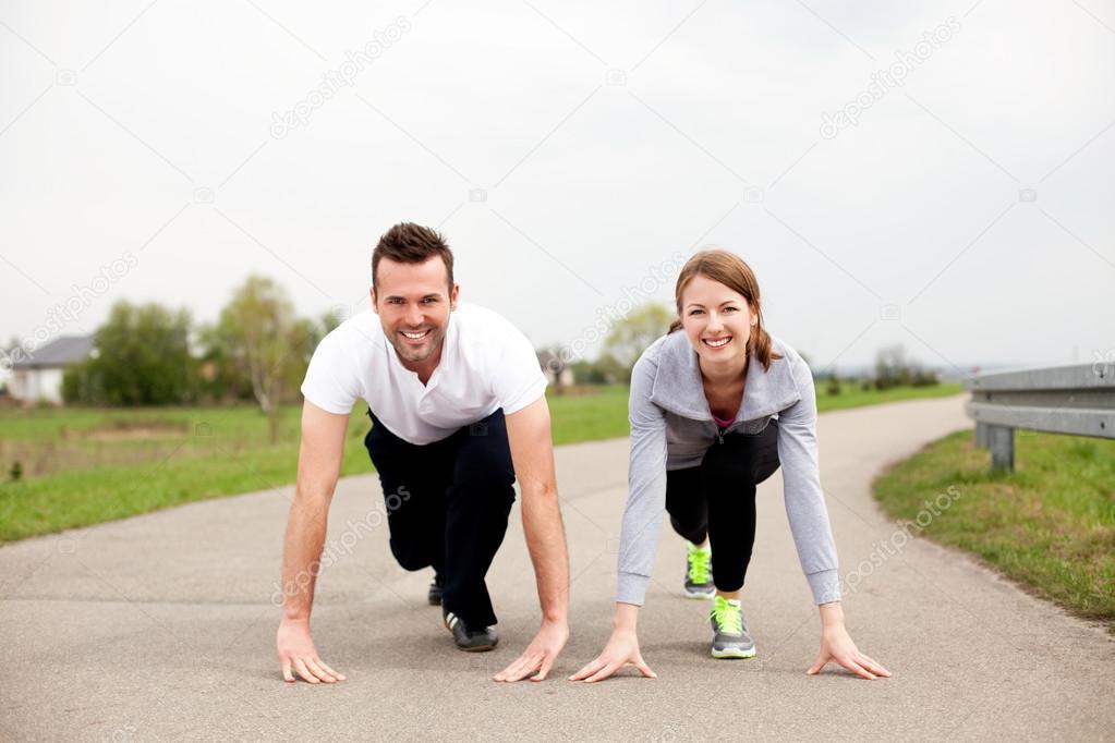 Young couple prepare to start running