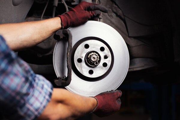 Car mechanic Repairing brakes on car