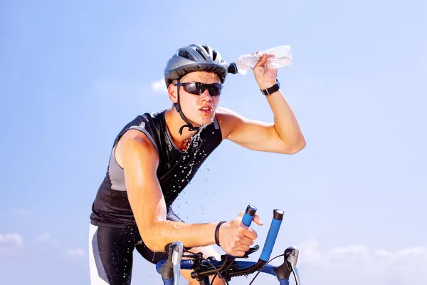Triathlete cycling on a bicycle — Stock Photo, Image