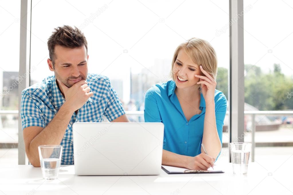 Couple discussing new project on the laptop