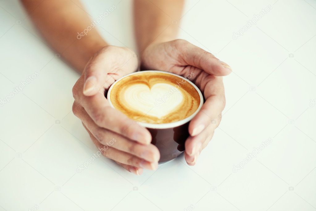 Female hands holding caffee