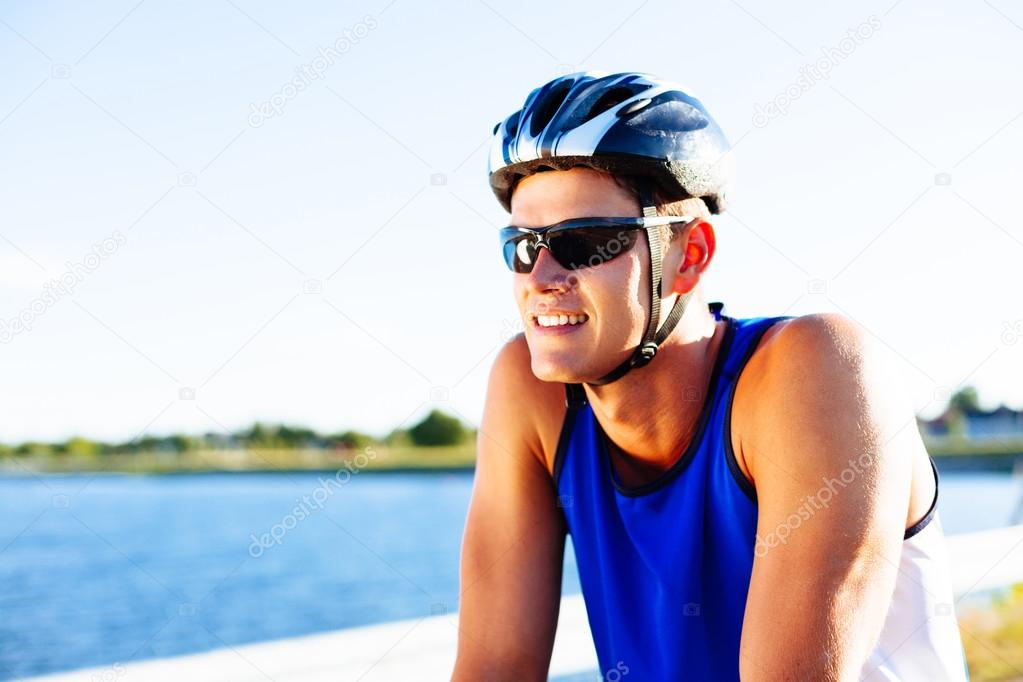 Happy young man riding bike