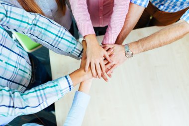 Group of corporate people joining hands clipart