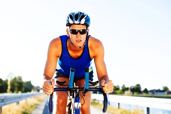 Triathlete cycling on a bicycle — Stock Photo, Image