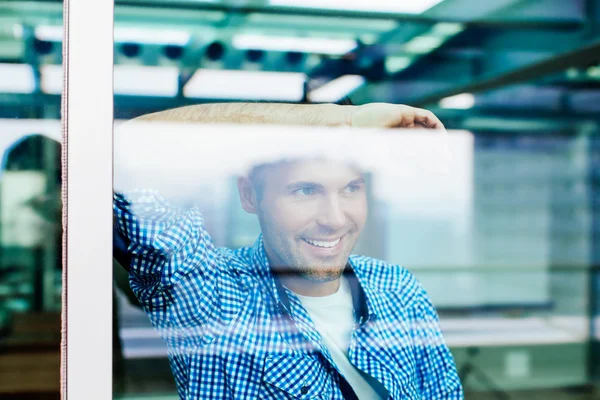 Handsome man looking through window — Stock Photo, Image