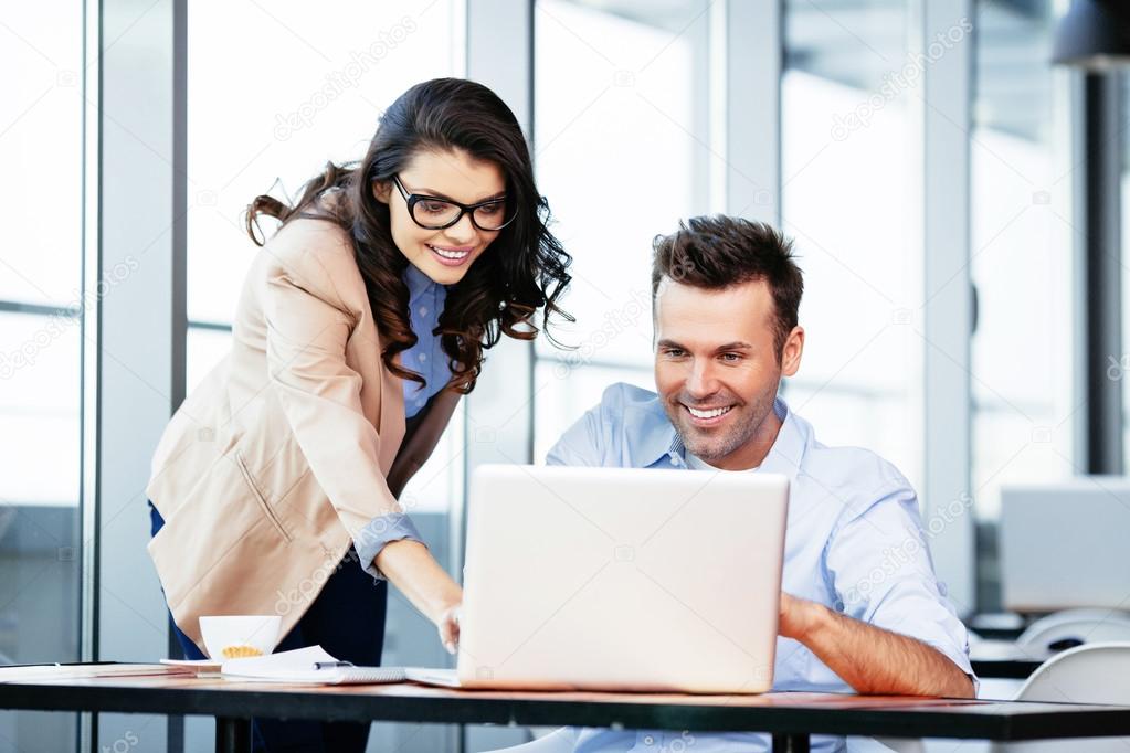 Business partners at front of laptop