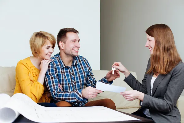 Couple receiving keys from estate agent — Stock Photo, Image