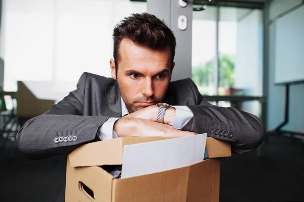 Laid off manager sitting down with carton — Stock Photo, Image