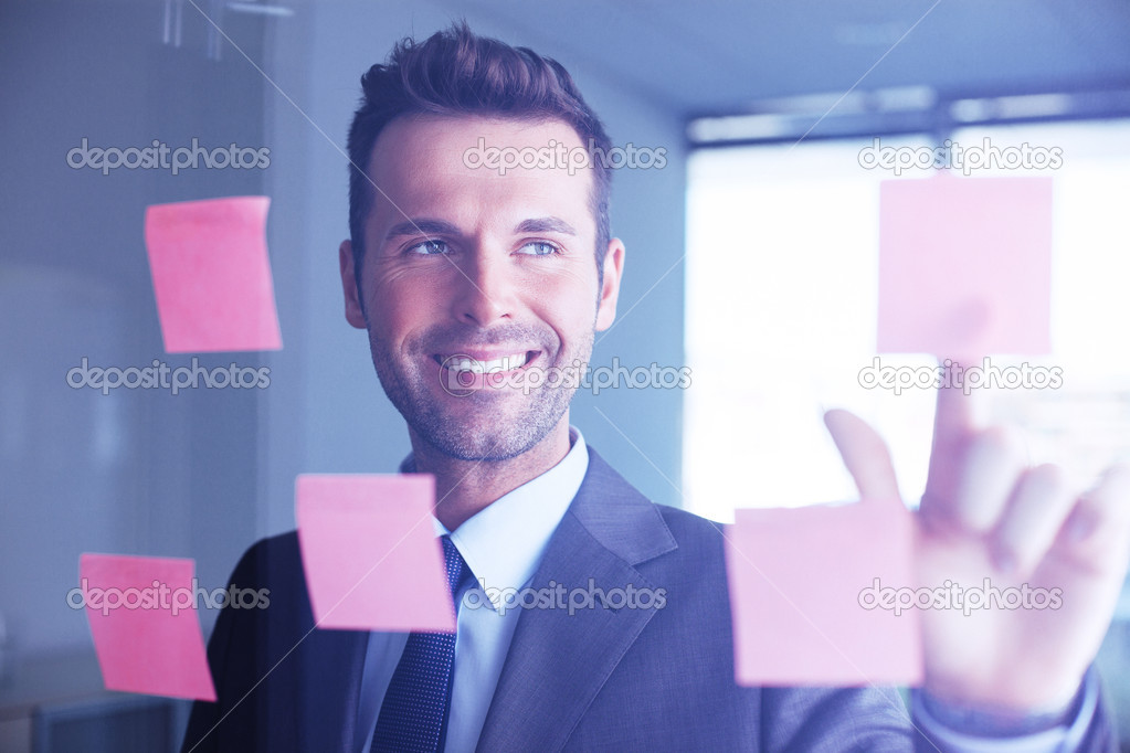 Professional putting his ideas onto sticky notes
