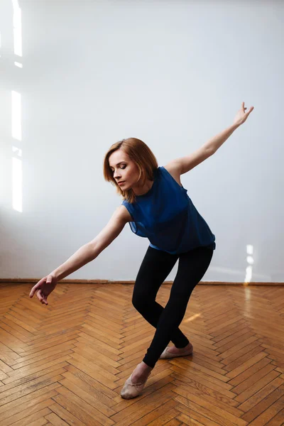 Female ballet dancer stretching her arms — Stock Photo, Image