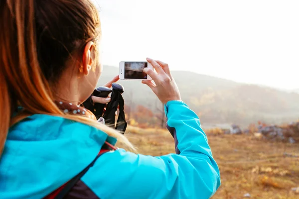 Kvindelig backpacker tager et billede - Stock-foto