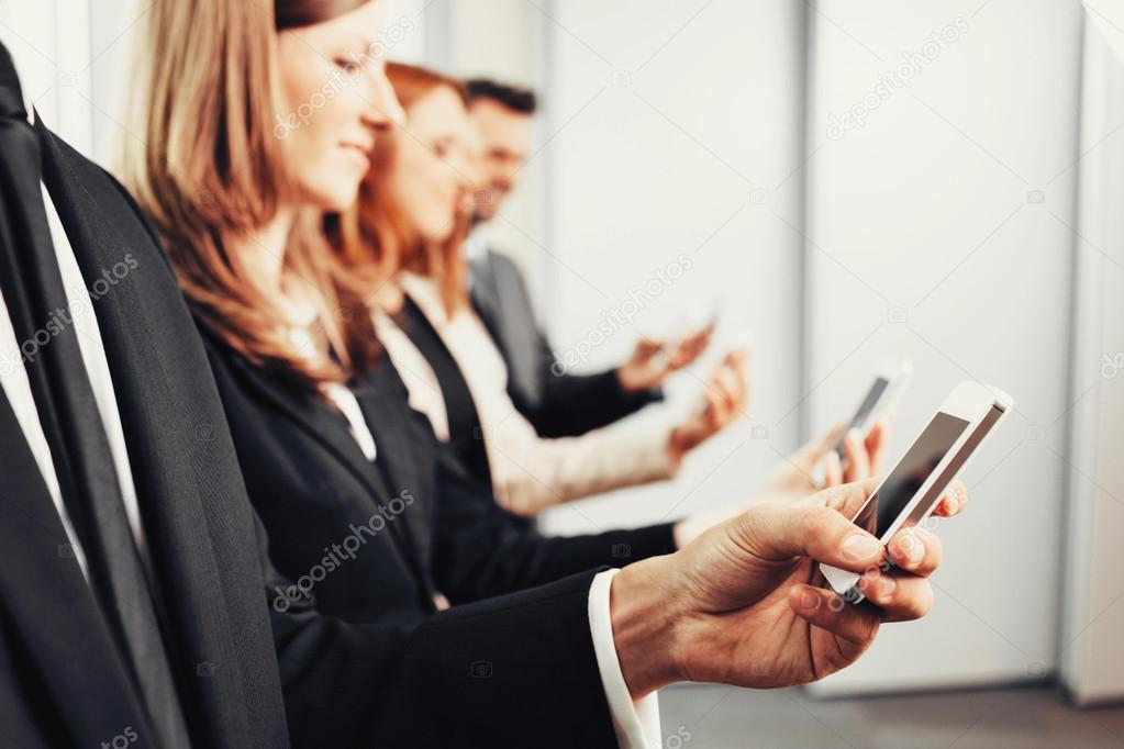 Business people using smartphones