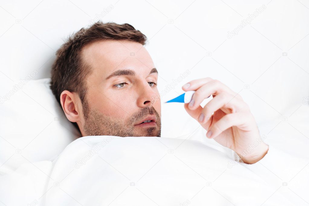 Man holding a thermometer