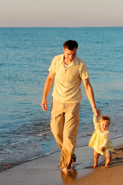 Otec s dítětem na břehu moře — Stock fotografie