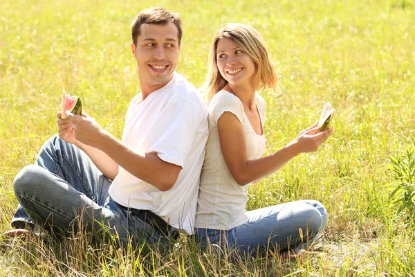 Couple in love eating watermelon outdoors — Stock Photo, Image